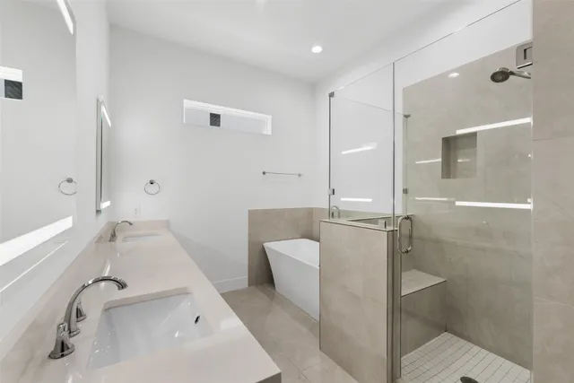 a bathroom with a bathtub and a shower