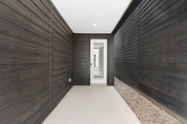 a view of a room with a white wall and wooden floor
