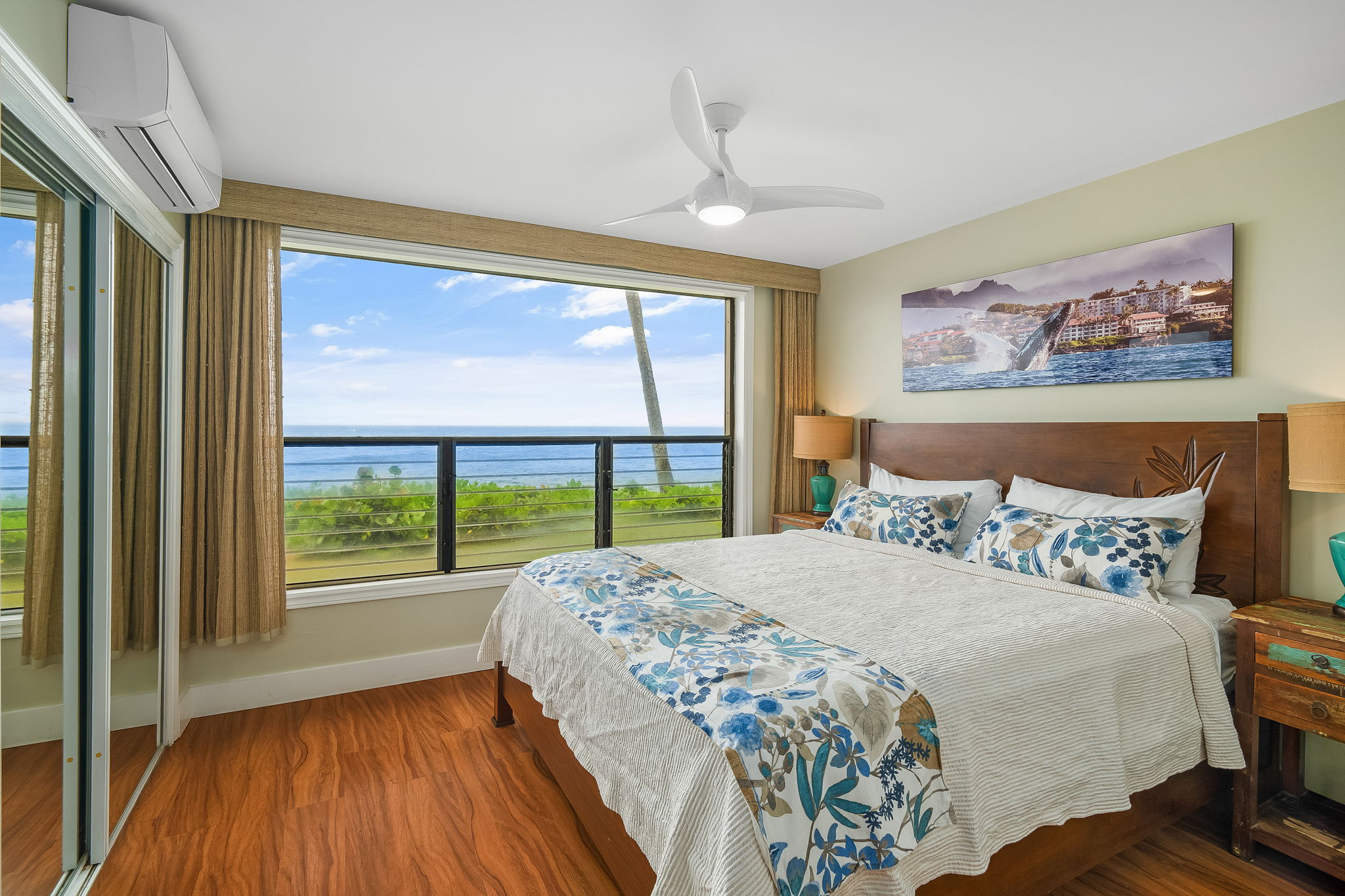 1775 Pe'e Road, Unit 101A Koloa, HI 96756 - Photo 11 of 25 a bedroom with a large bed and a large window with wooden floor