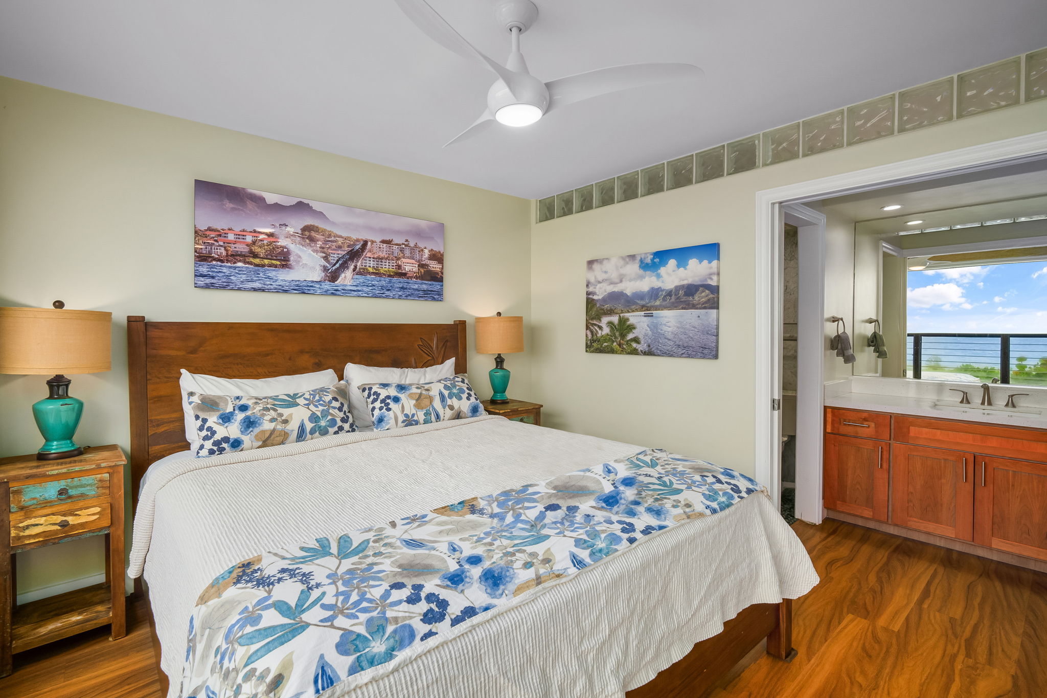 1775 Pe'e Road, Unit 101A Koloa, HI 96756 - Photo 12 of 25 a bedroom with a large bed and a chandelier