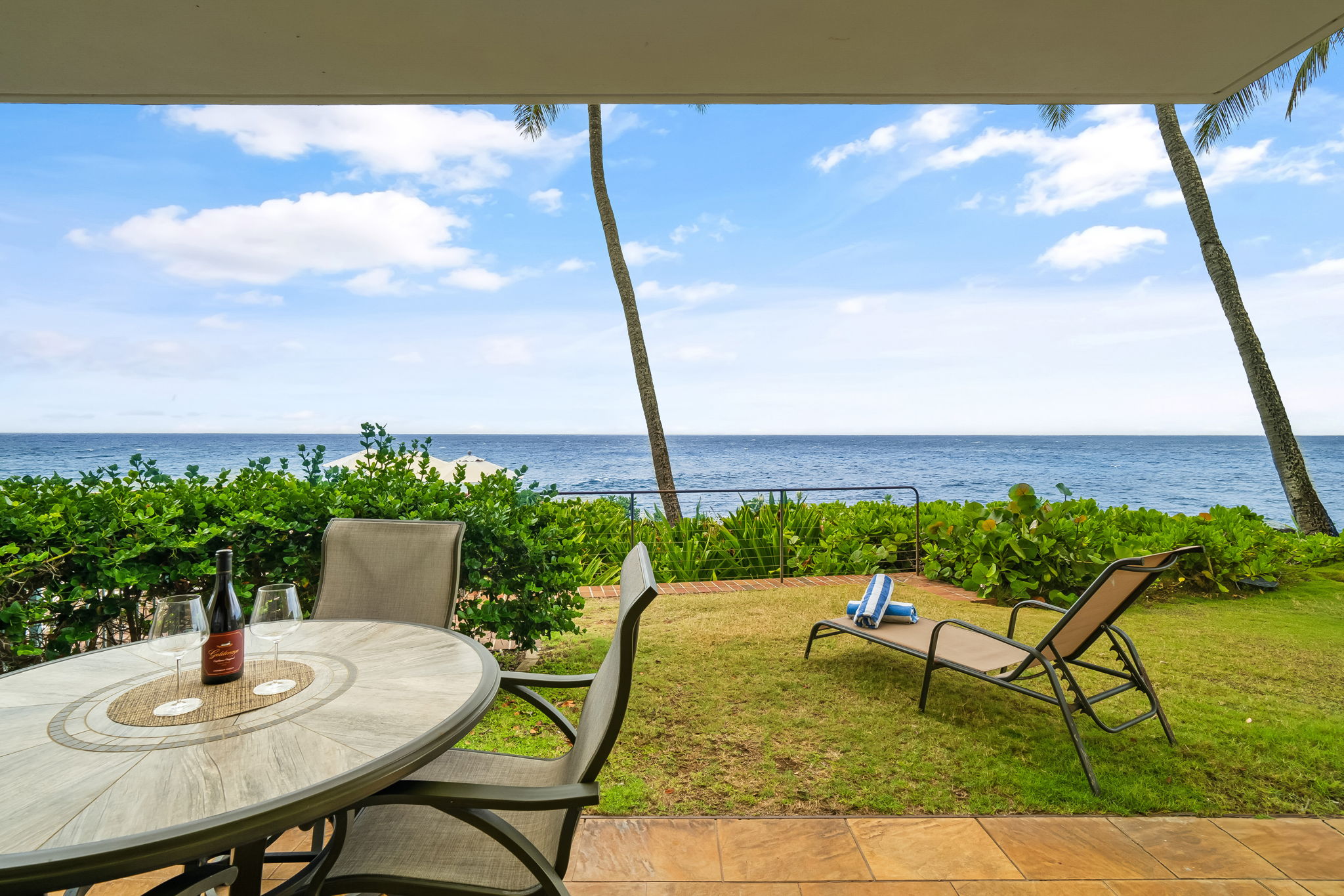 1775 Pe'e Road, Unit 101A Koloa, HI 96756 - Photo 20 of 25 a terrace with a table and chairs