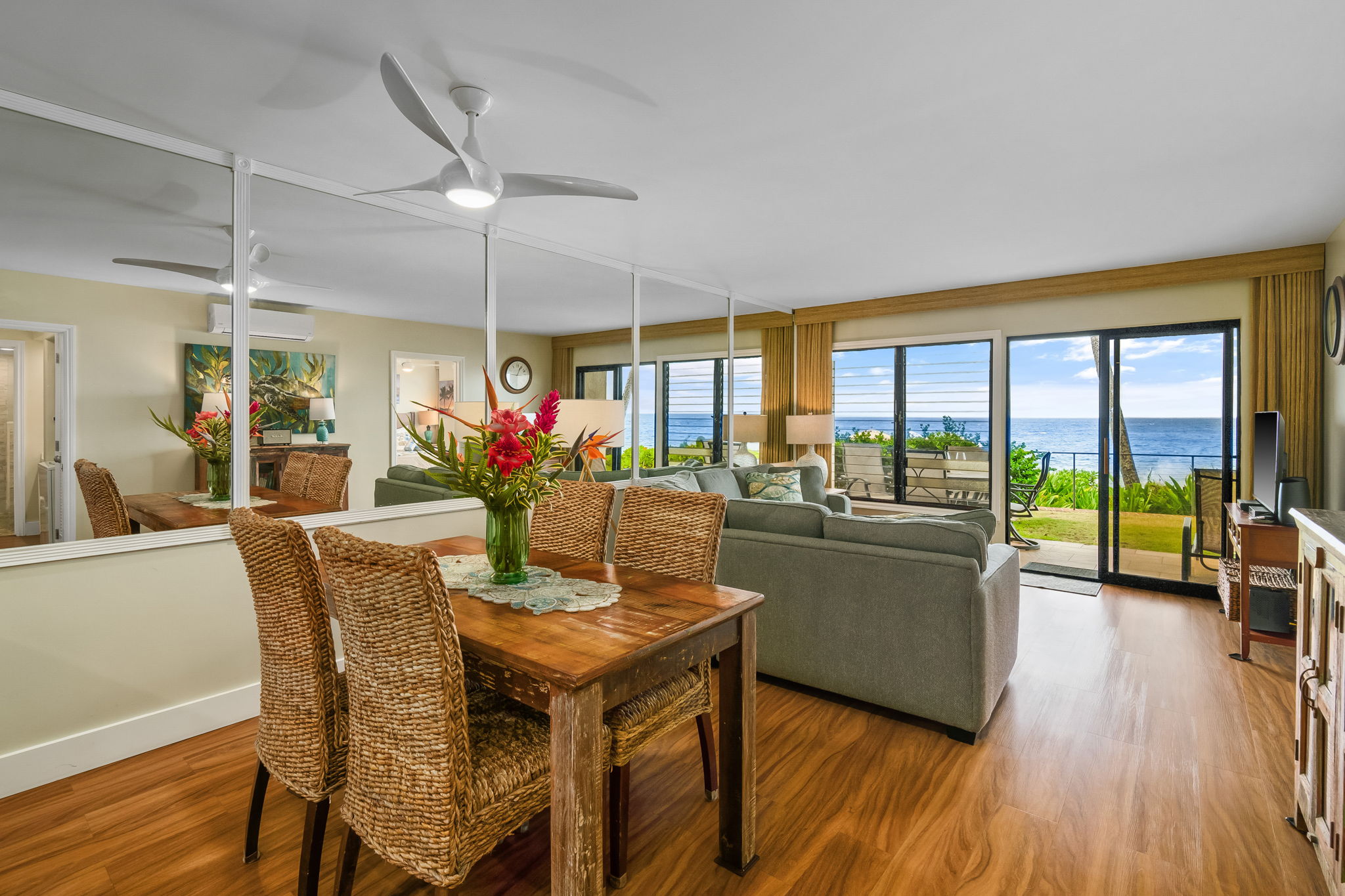 1775 Pe'e Road, Unit 101A Koloa, HI 96756 - Photo 4 of 25 a dining room with furniture wooden floor and a chandelier