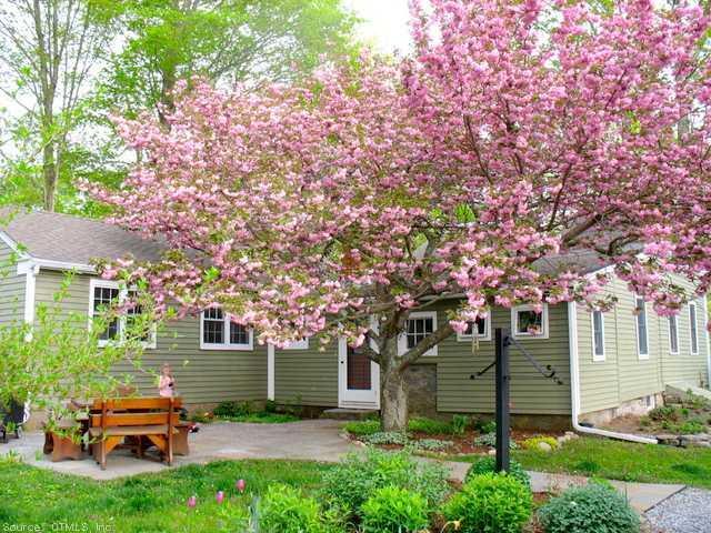 374 McVeagh Road Westbrook, CT 06498 - Photo 1 of 1 a backyard of a house with table and chairs