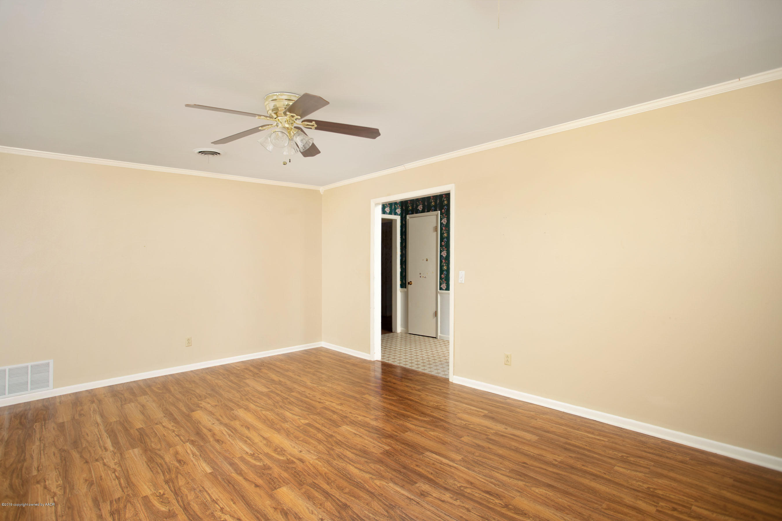 6018 Jameson Road Amarillo, TX 79106 - Photo 6 of 24 a view of a big room with wooden floor and chandelier fan