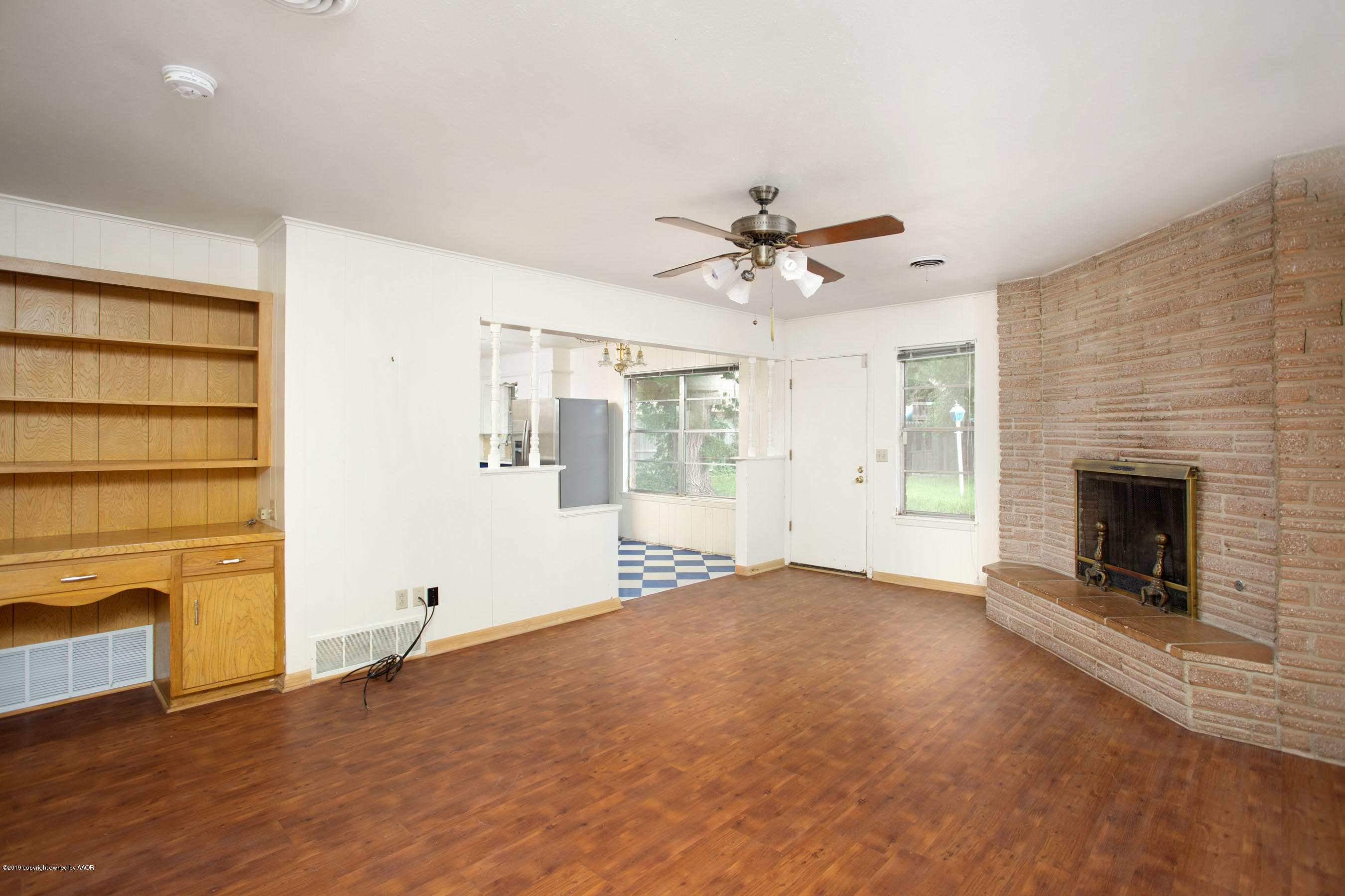 6018 Jameson Road Amarillo, TX 79106 - Photo 8 of 24 a view of an empty room with a fireplace and a window