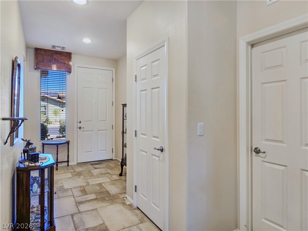 2485 Morrow Ridge Place Laughlin, NV 89029 - Photo 8 of 40 Welcoming entry with durable tile flooring and naturally illuminated spaces, perfect for greeting guests.