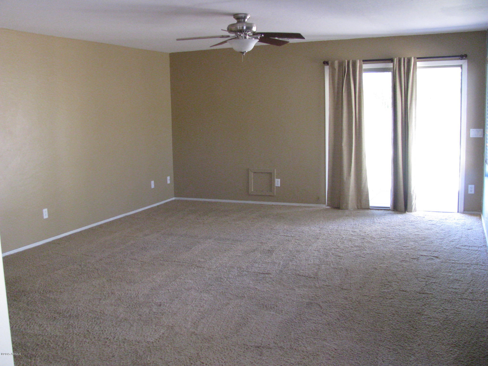 2302 West Maldonado Road Phoenix, AZ 85041 - Photo 11 of 19 a view of an empty room with a window