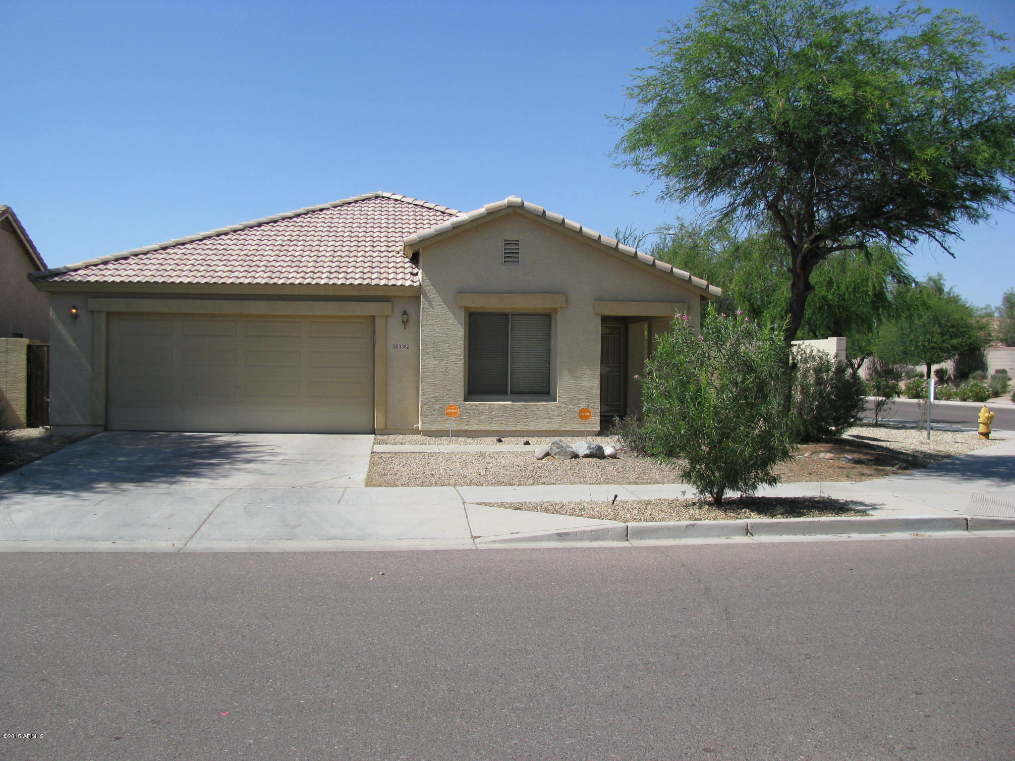 2302 West Maldonado Road Phoenix, AZ 85041 - Photo 2 of 19 a front view of a house with a yard and garage
