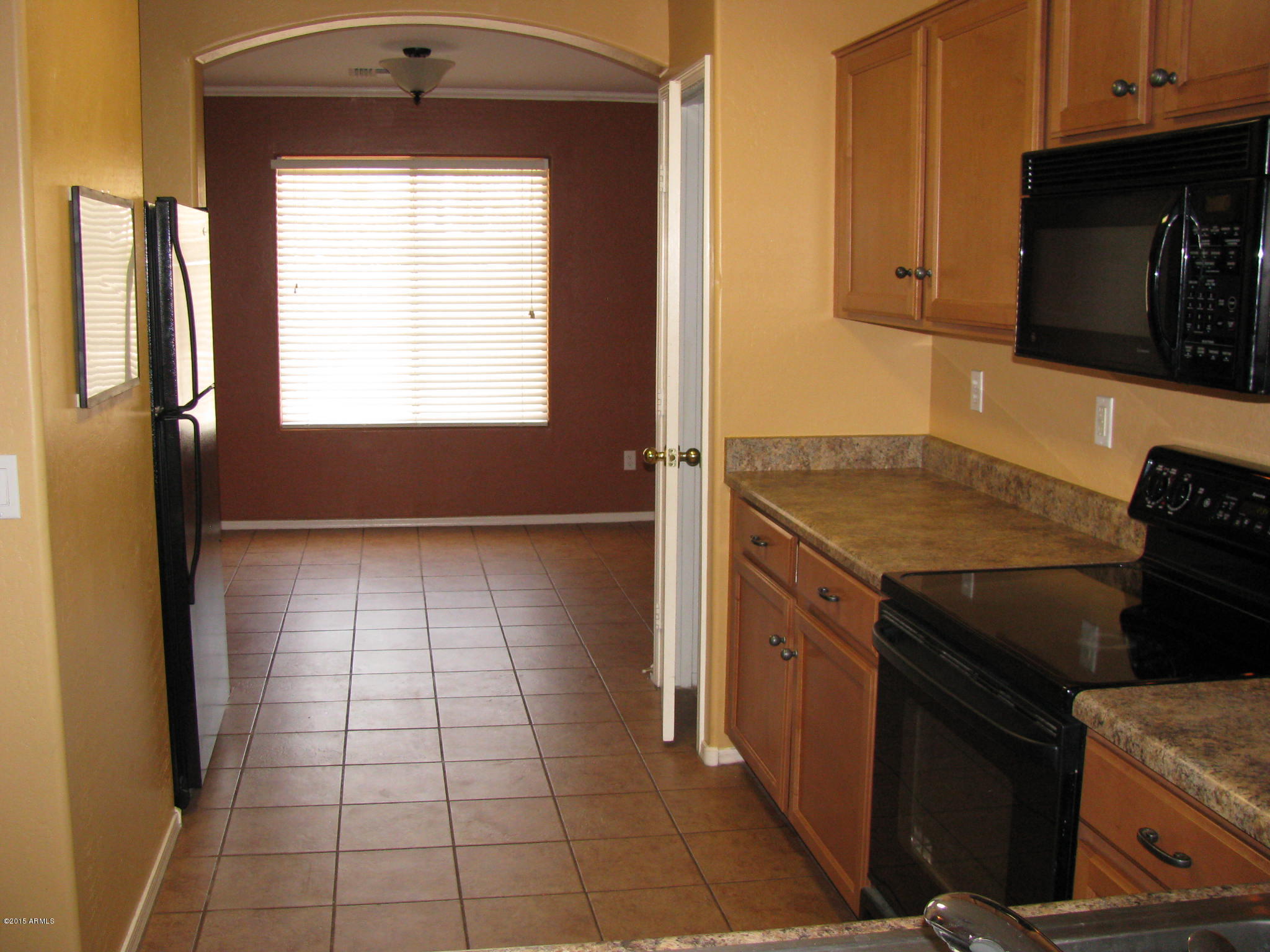 2302 West Maldonado Road Phoenix, AZ 85041 - Photo 5 of 19 a kitchen with a stove a sink and a microwave