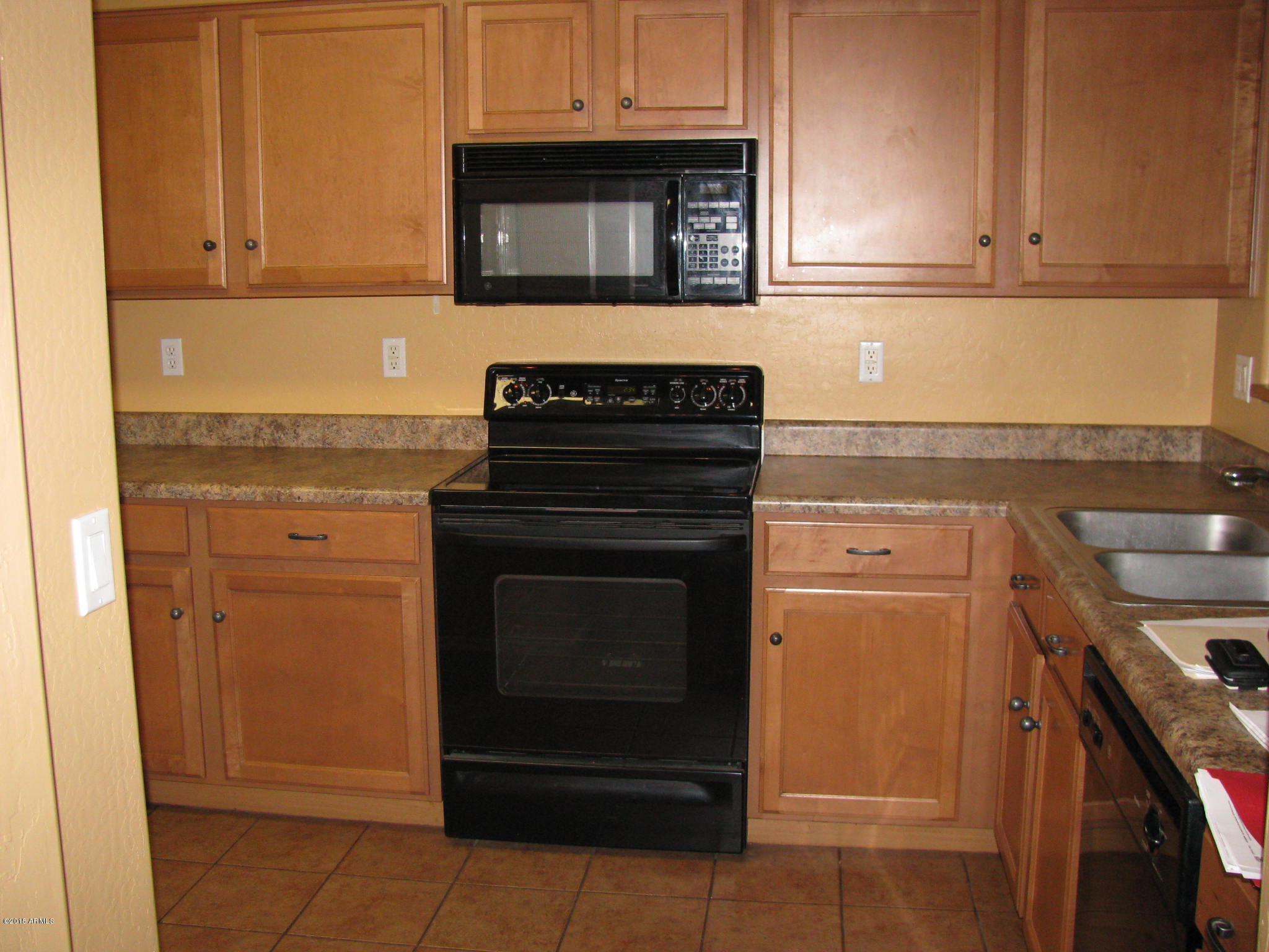 2302 West Maldonado Road Phoenix, AZ 85041 - Photo 6 of 19 a kitchen with granite countertop white cabinets and stainless steel appliances