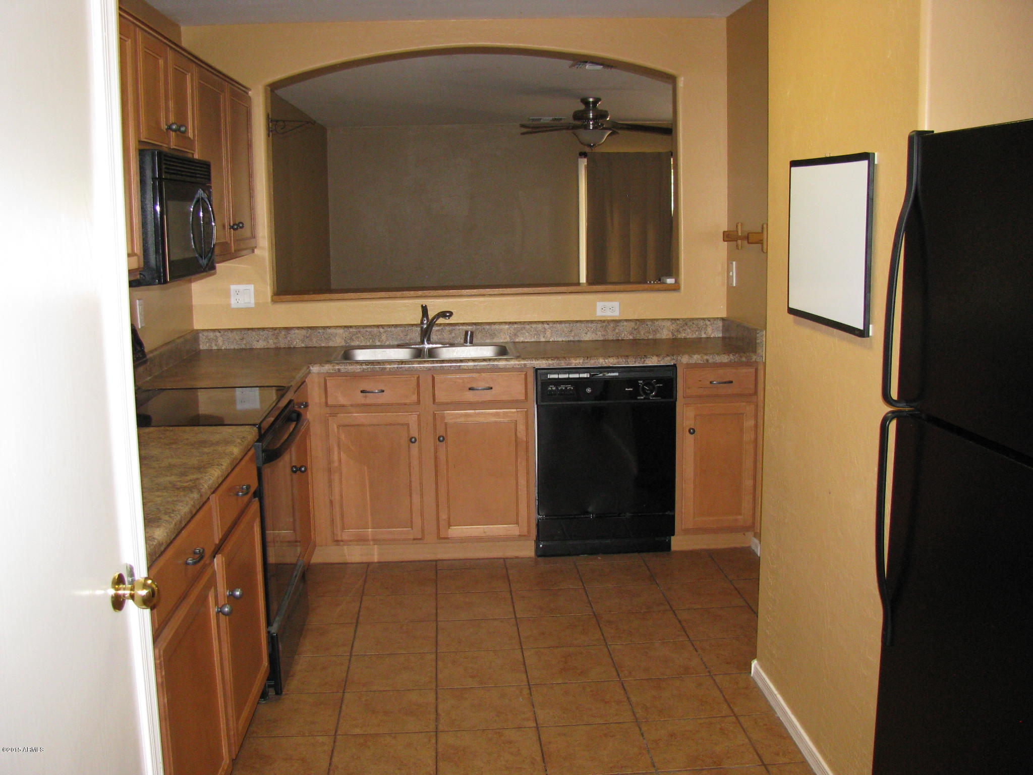 2302 West Maldonado Road Phoenix, AZ 85041 - Photo 8 of 19 a bathroom with a sink and a refrigerator