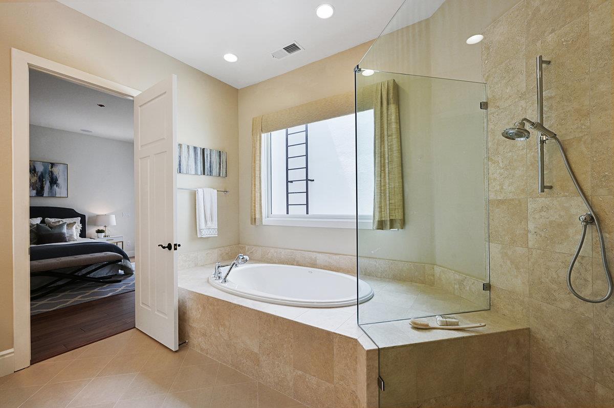 782 Dixon Way Los Altos, CA 94022 - Photo 28 of 38 a bathroom with a granite countertop sink a mirror a bathtub and shower