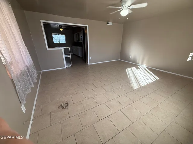 a view of a hallway with wooden shelves and stairs