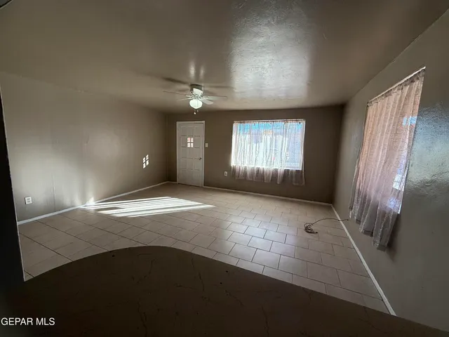 a view of a kitchen with cabinet and a refrigerator