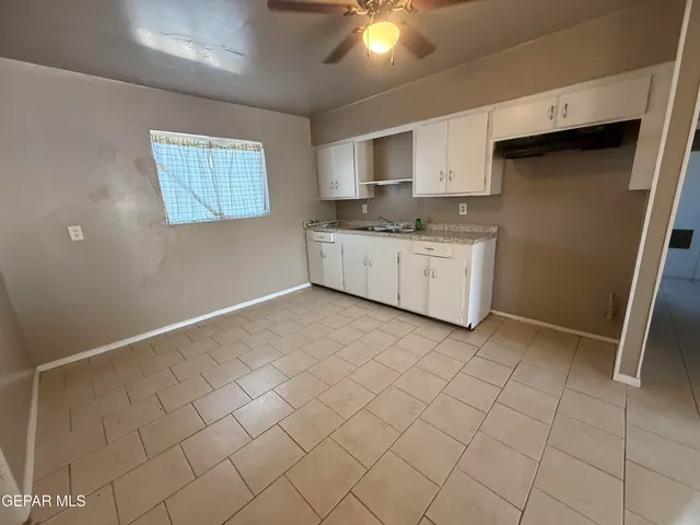 a open kitchen with cabinets a sink and appliances