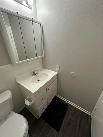 a bathroom with a sink toilet and mirror
