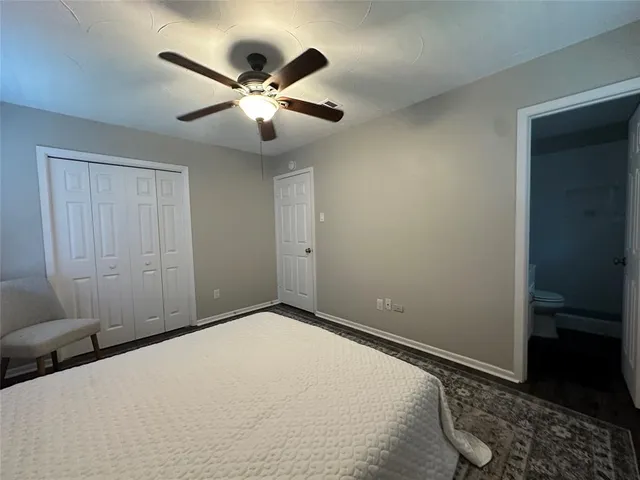 a view of a livingroom with a ceiling fan and wooden floor