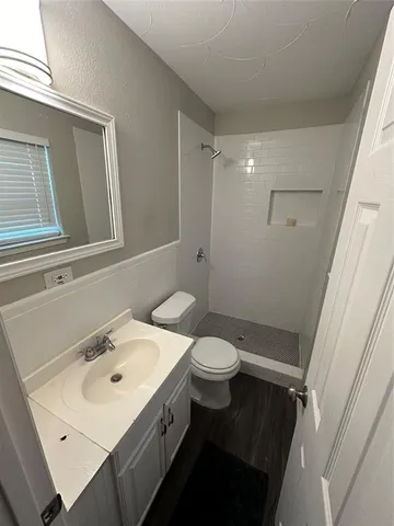 a bathroom with a sink toilet and mirror