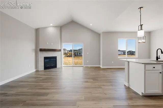 a view of a kitchen with a sink and wooden floor