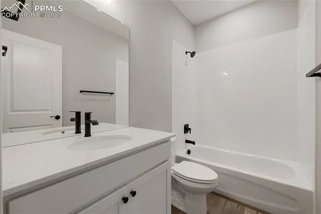 a very nice looking room with wooden floor and windows