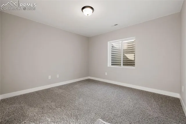 a spacious bathroom with a sink a toilet a shower and a mirror