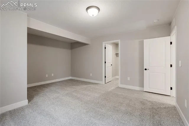 an empty room with wooden floor and closet