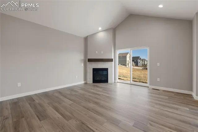 a view of a kitchen with a sink oven cabinets and wooden floor