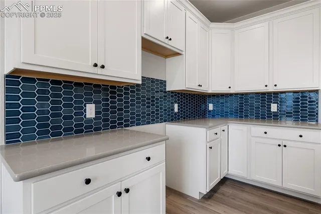 a kitchen with kitchen island granite countertop a sink and cabinets