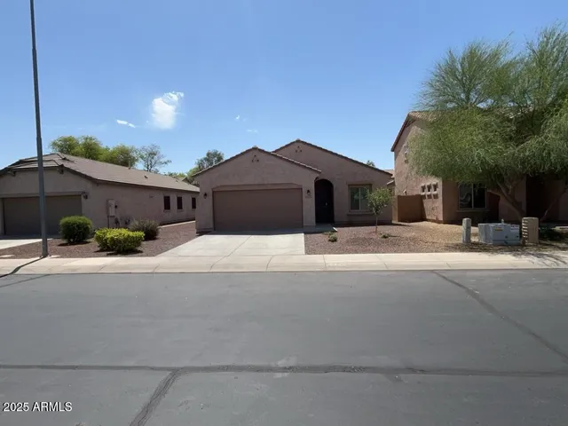 a front view of a house with a yard and a garage