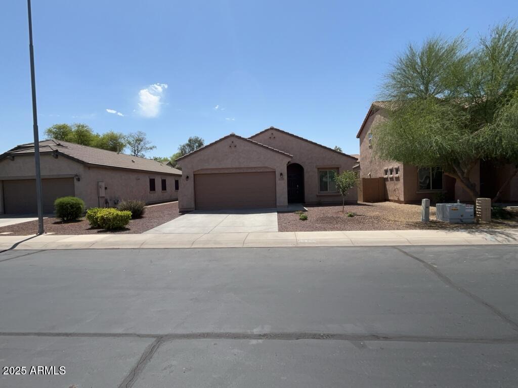 a front view of a house with a yard and a garage