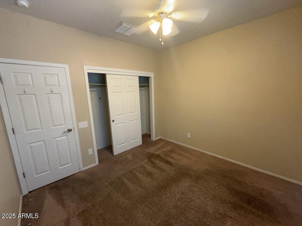 11021 East Sutter Avenue Mesa, AZ 85212 - Photo 10 of 26 an empty room with closet and a chandelier fan