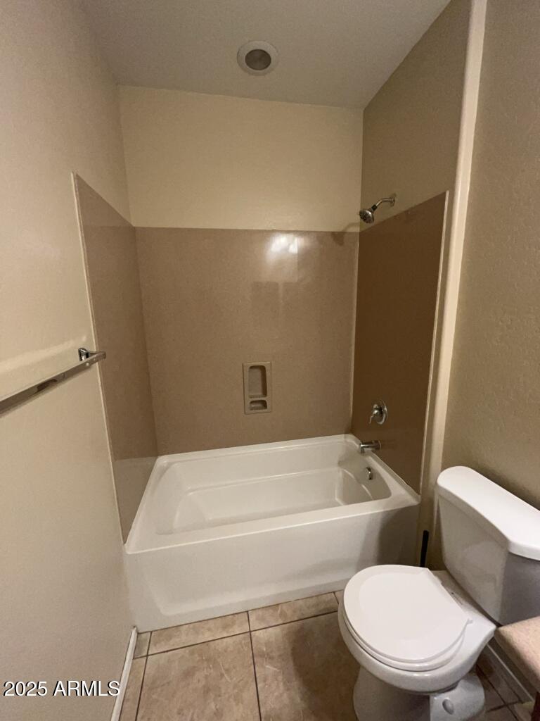 11021 East Sutter Avenue Mesa, AZ 85212 - Photo 14 of 26 a white toilet sitting next to a bath tub