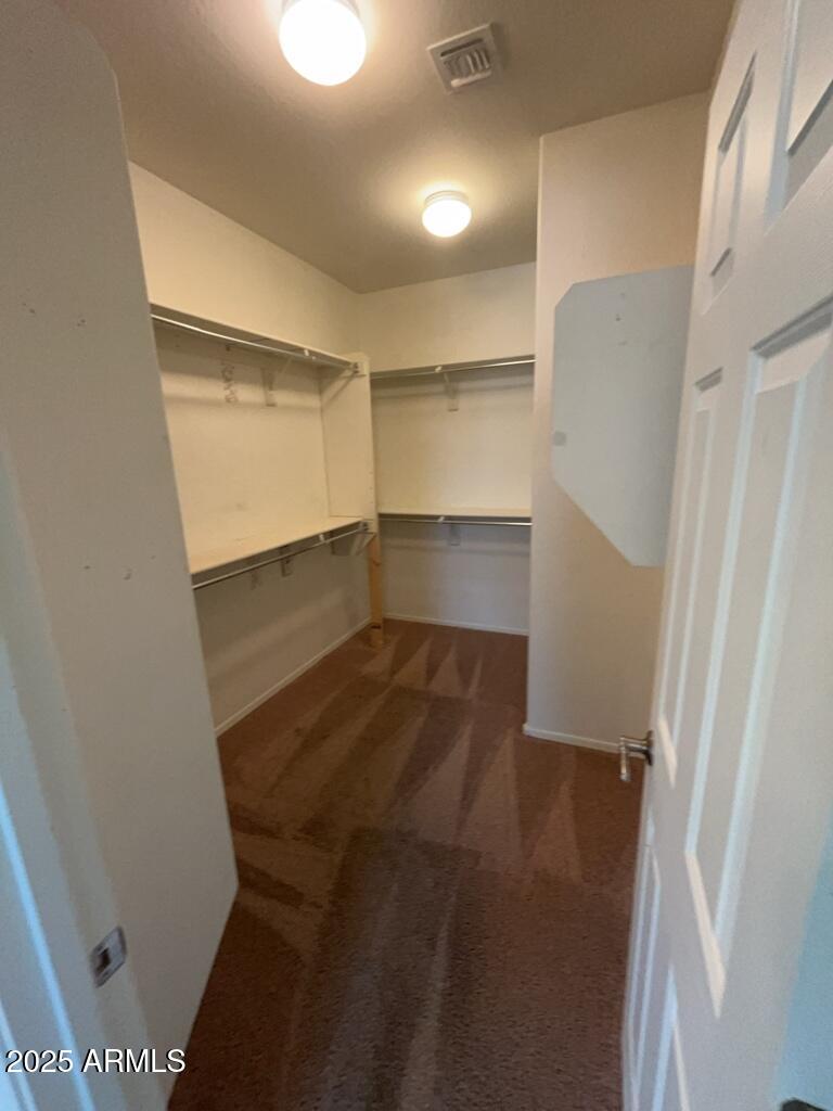 11021 East Sutter Avenue Mesa, AZ 85212 - Photo 18 of 26 a view of walk in closet with empty racks