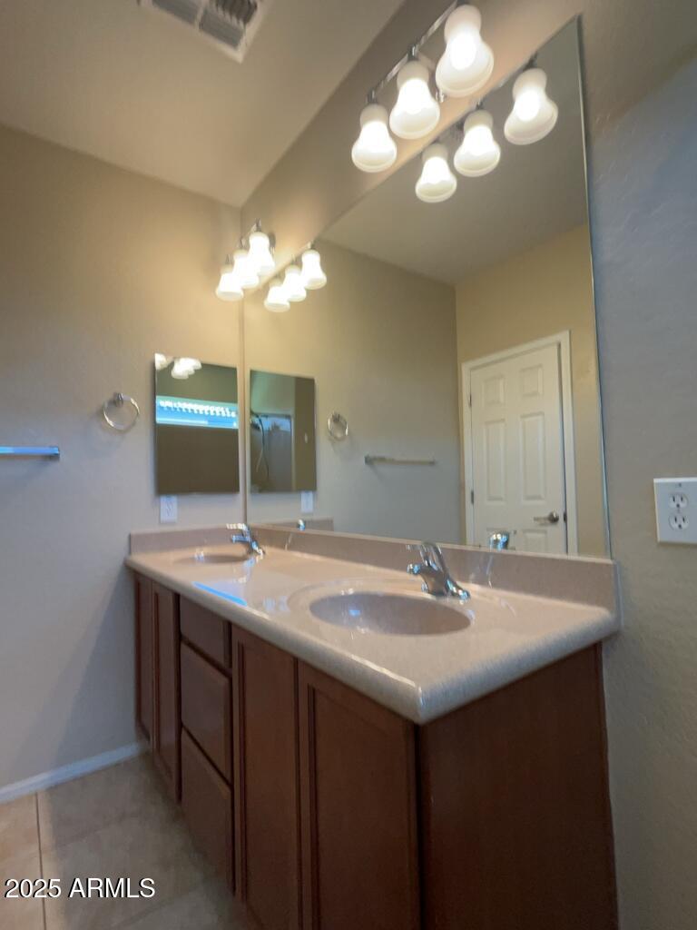 11021 East Sutter Avenue Mesa, AZ 85212 - Photo 20 of 26 a bathroom with a sink and a mirror
