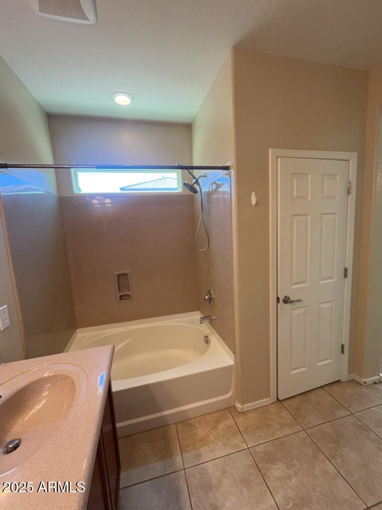 11021 East Sutter Avenue Mesa, AZ 85212 - Photo 21 of 26 a bathroom with a tub sink and vanity