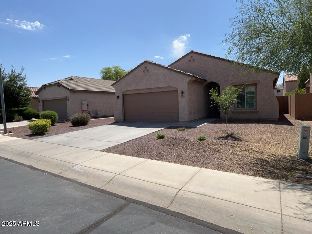 11021 East Sutter Avenue Mesa, AZ 85212 - Photo 2 of 26 a front view of a house with a yard and garage