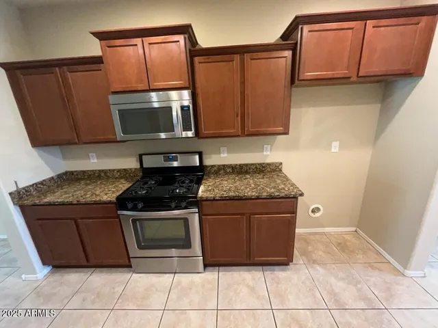 a view of an empty room with a kitchen