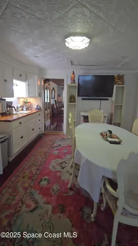 a large kitchen with a table and chairs