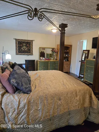 a bedroom with a bed and dresser