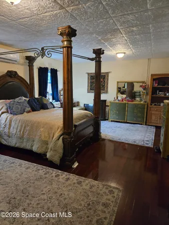 a bedroom with a large bed and a chandelier