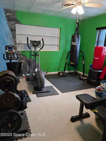 a bedroom with a bed and a flat tv screen on dresser