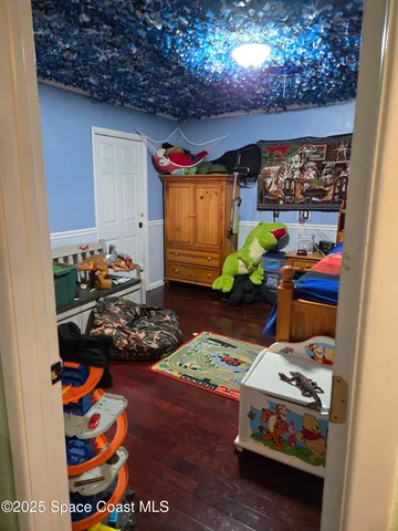 a bedroom with a bed and flat screen tv