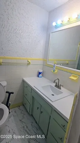 a view of a garage with a bike and wooden floor
