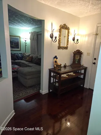 a living room with furniture and a mirror