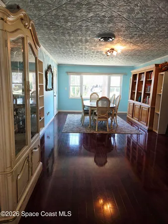 a dining room with furniture and wooden floor