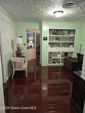 a view of living room with furniture and wooden floor
