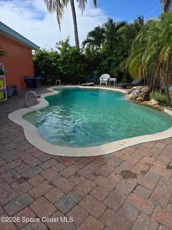 a view of a swimming pool with a yard