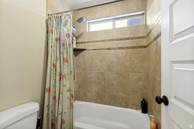 40 Wheeler Road Heber City, UT 84032 - Photo 17 of 41 Tile-surround shower with an integrated shelf, transom window, and white tub