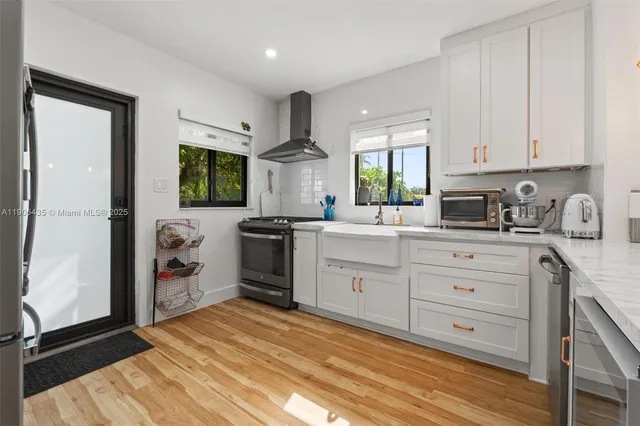 a kitchen with a refrigerator and a stove top oven