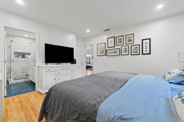 a bathroom with a granite countertop sink a toilet a shower and a mirror